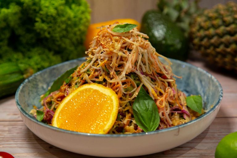 A bowl of salad with oranges and lemons