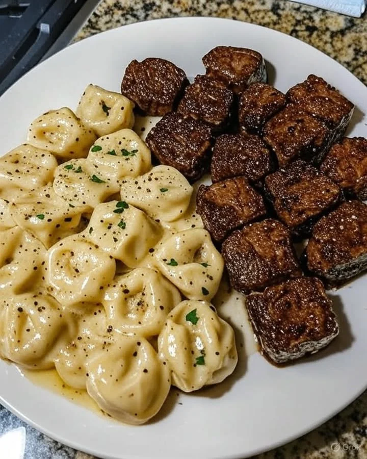 Delicious garlic butter steak bites served with creamy alfredo tortellini