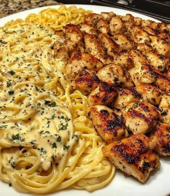 Creamy chicken pasta dish garnished with herbs in a bowl