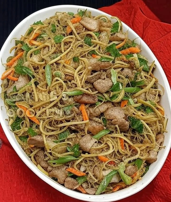 Delicious Pancit Canton Bihon served with fresh vegetables and meat