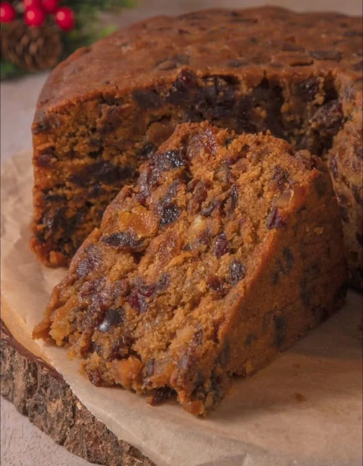 Delicious homemade Christmas fruit cake adorned with dried fruits and nuts