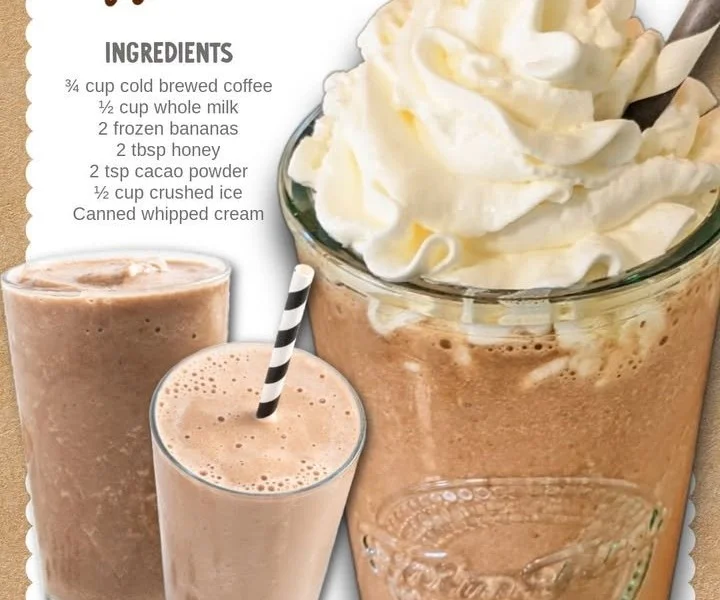 Delicious coffee smoothie topped with whipped cream and cocoa powder