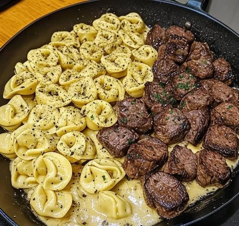 Creamy garlic steak garnished with herbs, served on a plate.