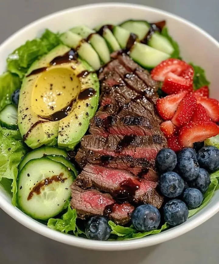 Delicious steak salad topped with fresh greens and dressing