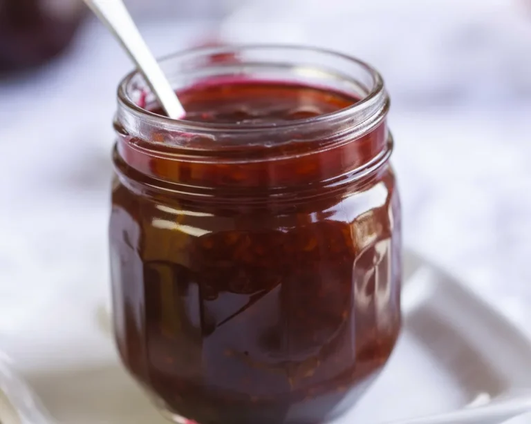 A variety of homemade jams made from fresh fruits in jars.