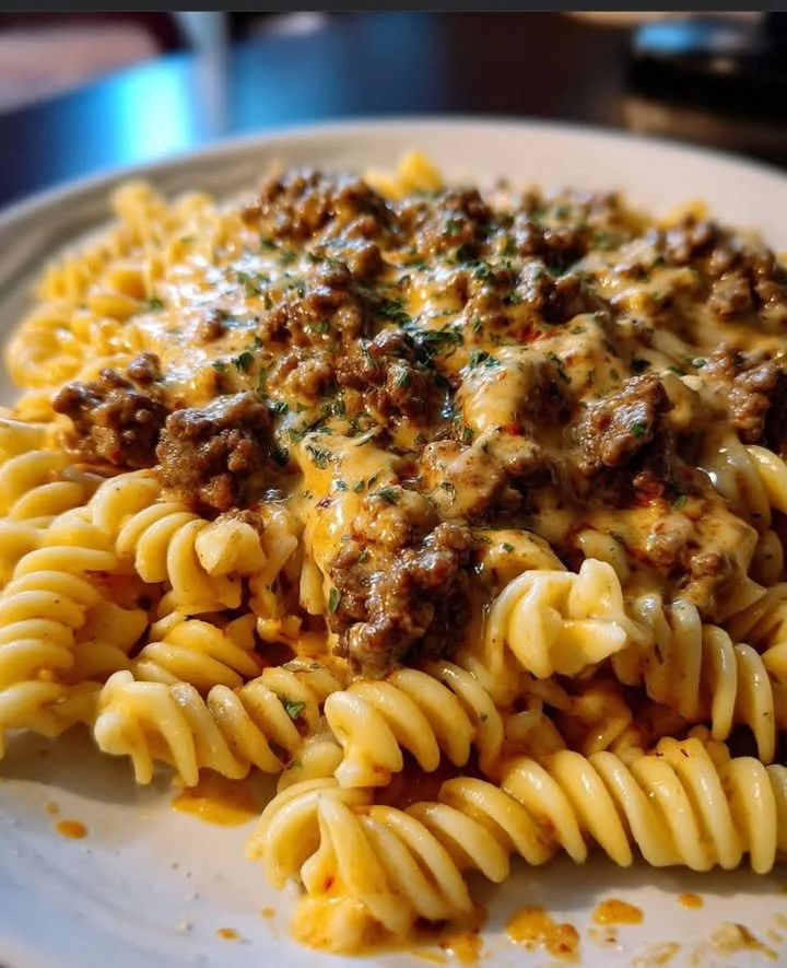 Delicious cheesy rotini pasta with melted cheese and herbs