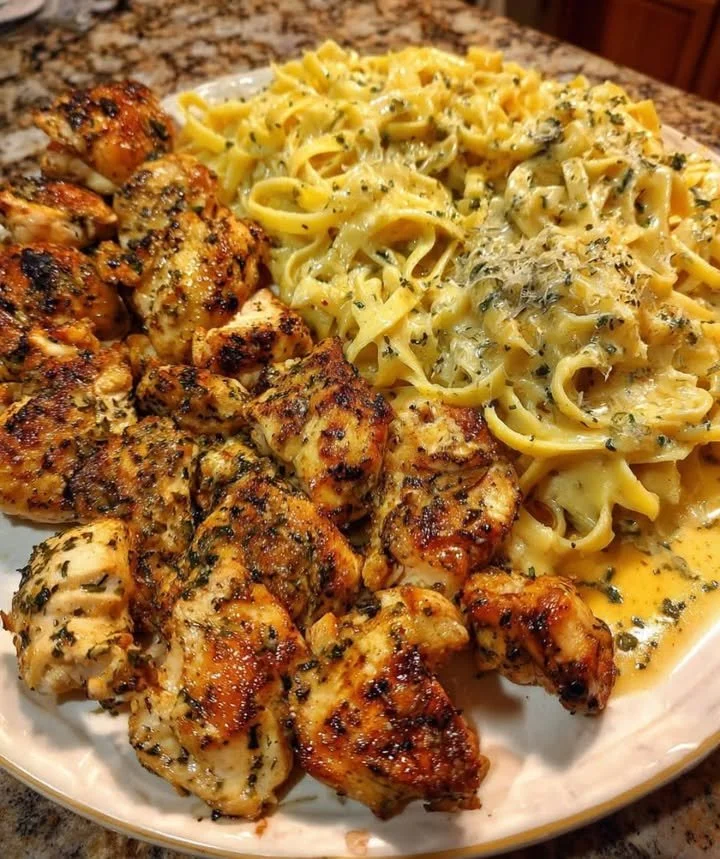 Delicious Cajun chicken bites on a bed of creamy pasta