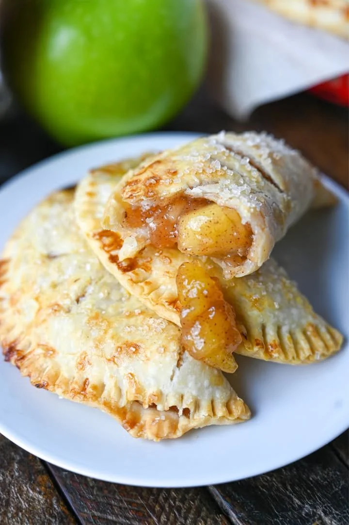 Freshly baked apple hand pies with golden crust and apple filling