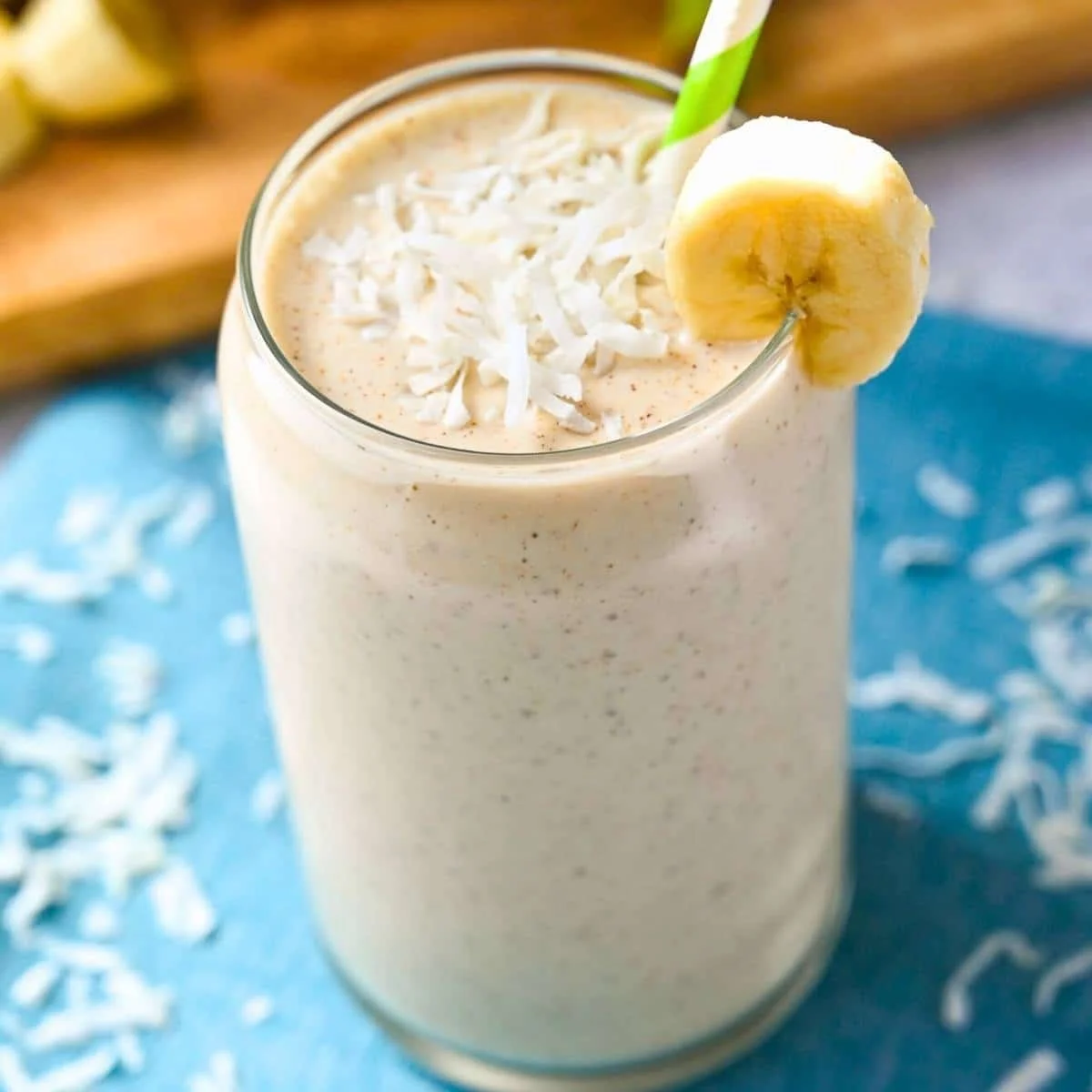 Delicious Banana Coconut Shake topped with coconut flakes and banana slices