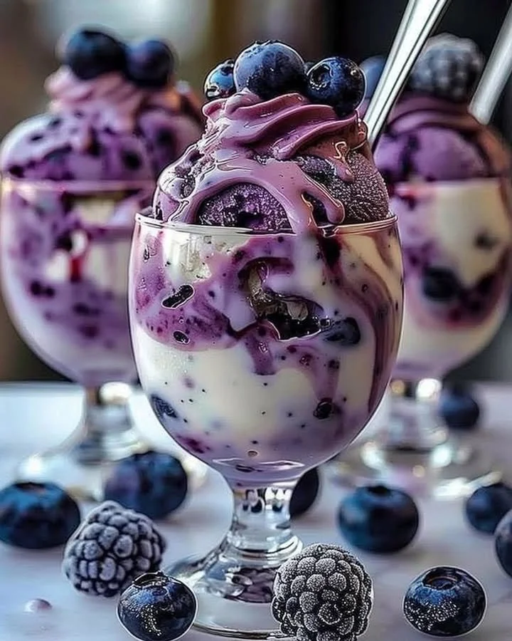 Delicious bowl of blueberry ice cream topped with fresh blueberries