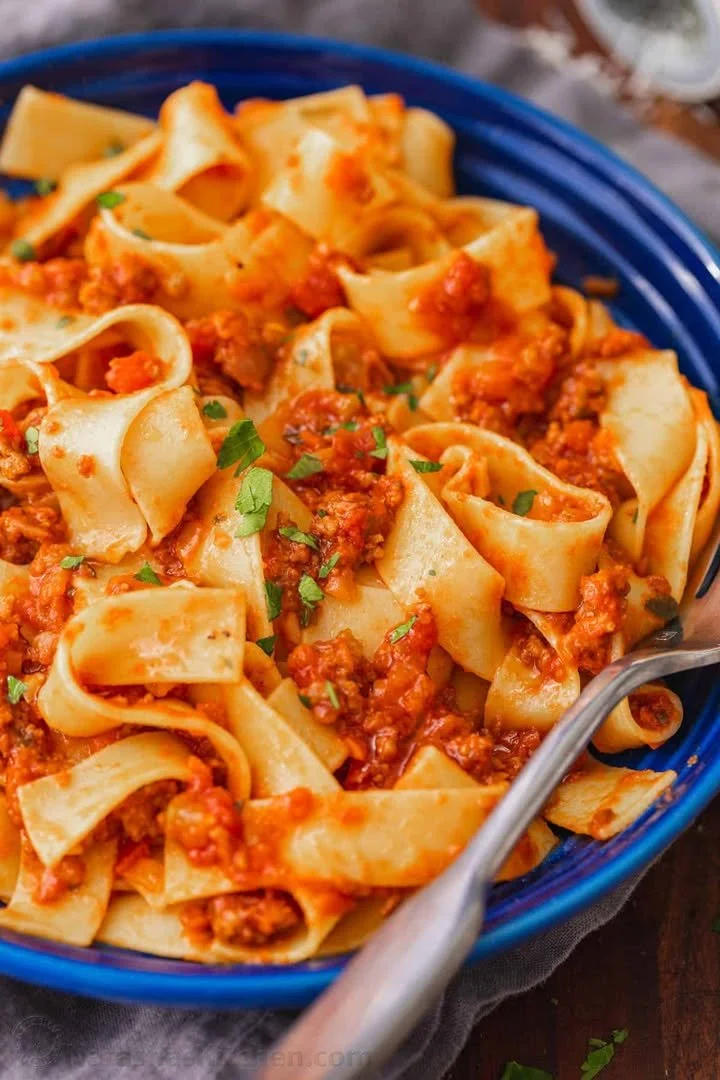 A rich and savory Bolognese sauce simmering in a pot, perfect for pasta dishes.
