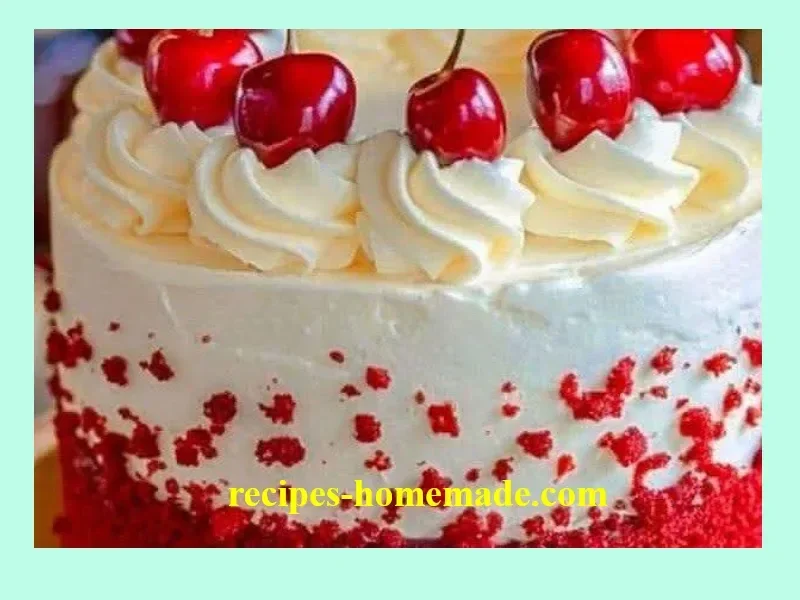 Slice of cherry cake with cherry cream cheese frosting on a white plate