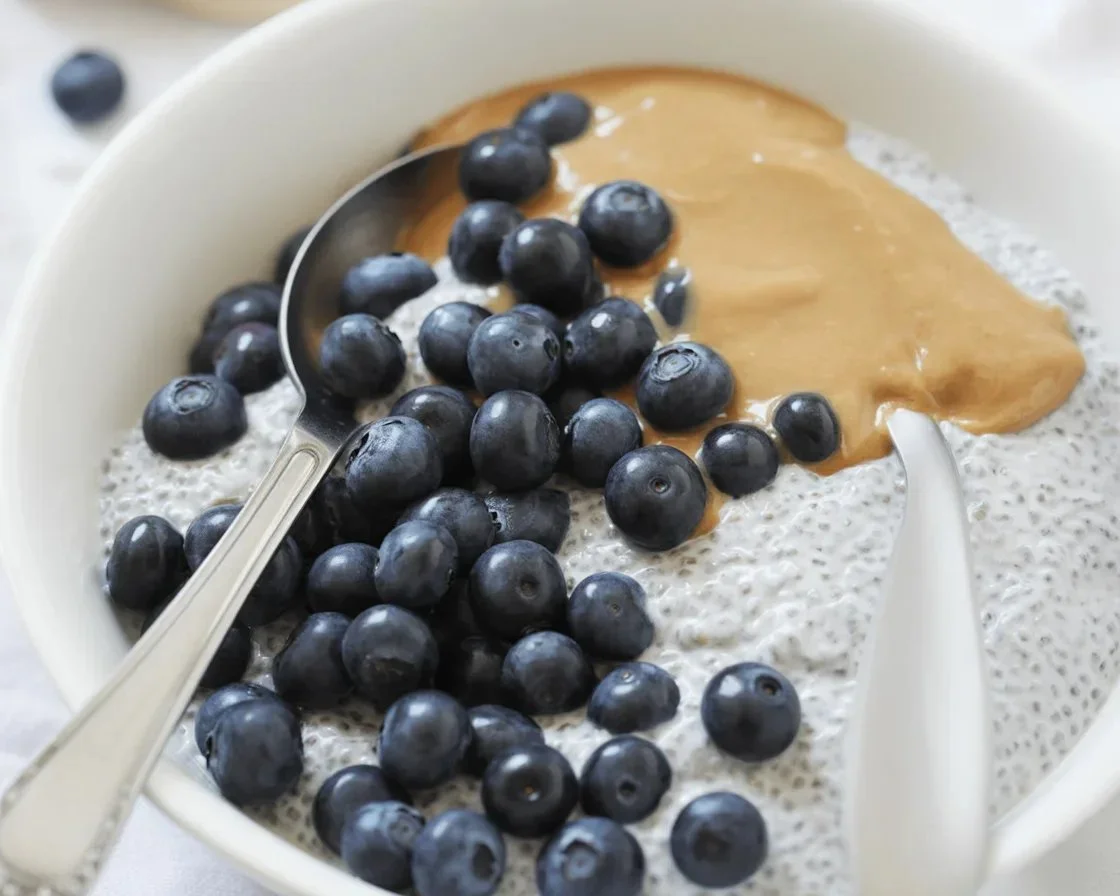 Chia seed pudding with almond butter and fresh berries in a rustic bowl
