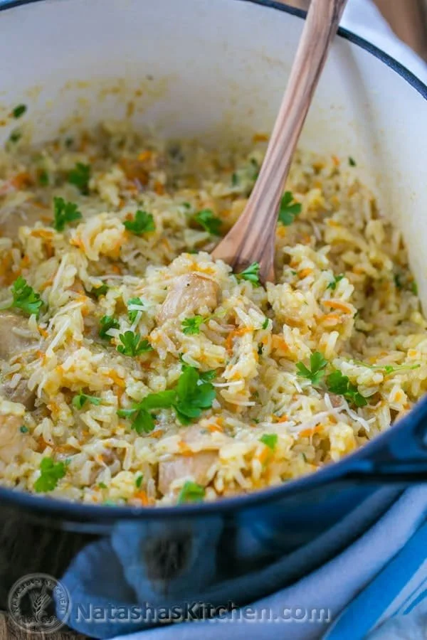 Delicious chicken and rice dish garnished with herbs and served on a plate