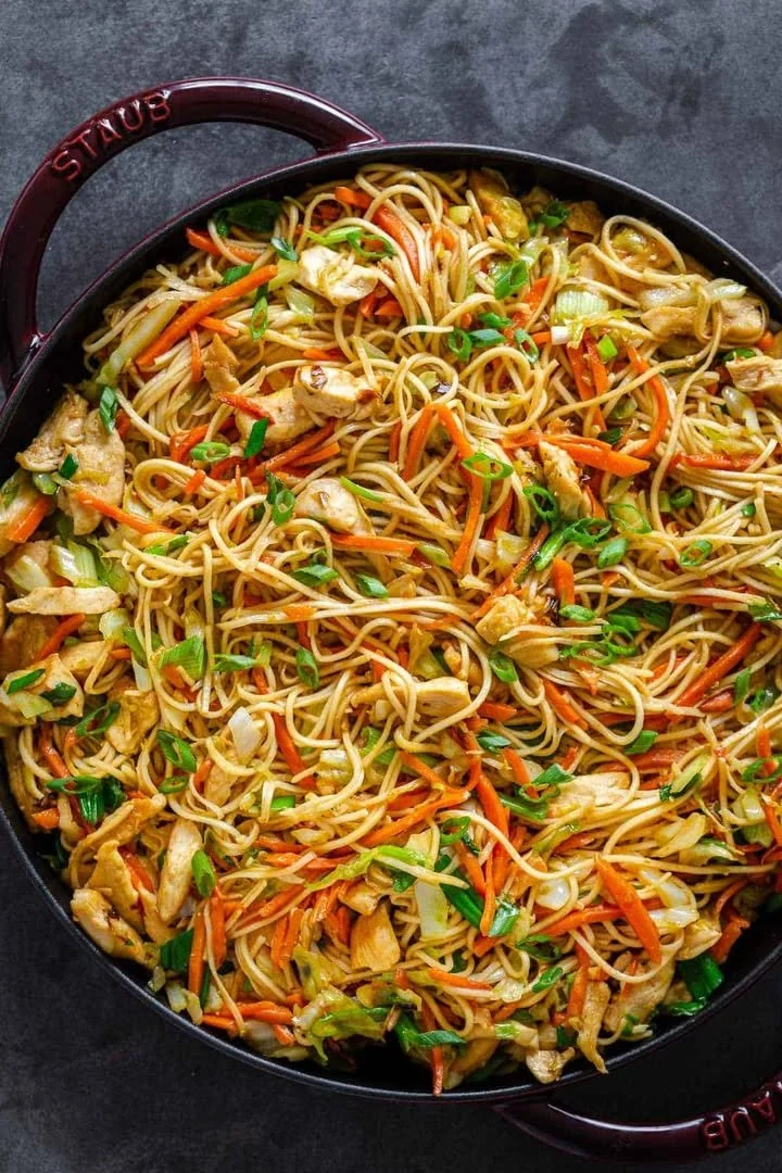 A delicious plate of Chicken Chow Mein with vegetables and chicken in a savory sauce.