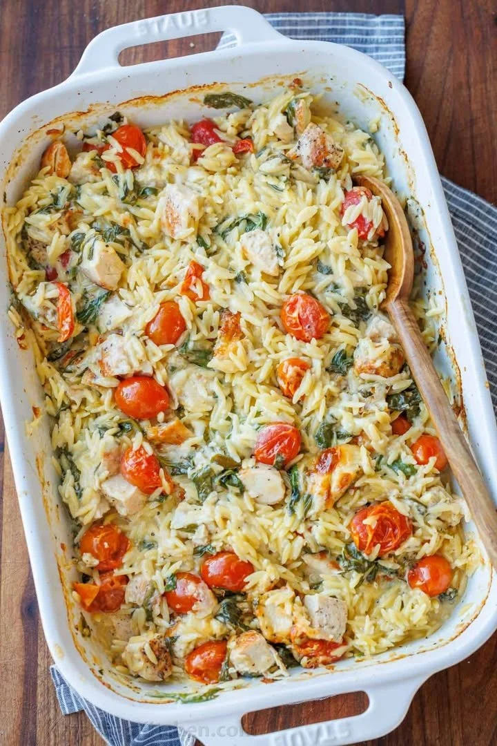 A hearty Chicken Orzo Bake with tender chicken and orzo pasta topped with herbs.