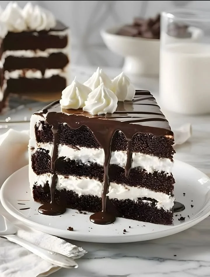 Delicious chocolate cake topped with rich chocolate frosting and decorative sprinkles