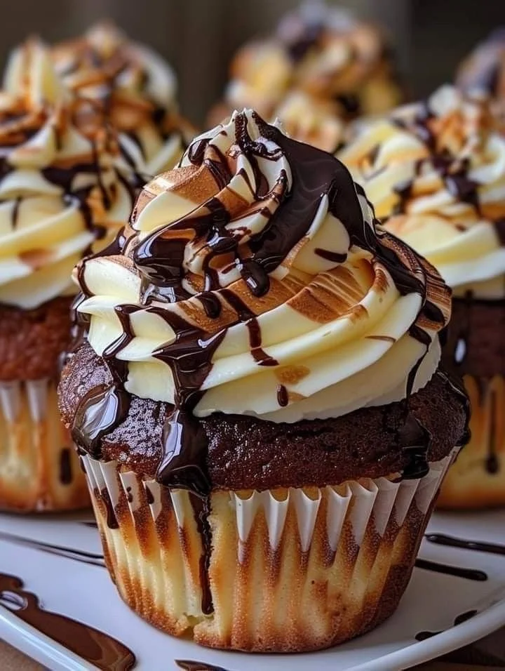 Chocolate vanilla swirl cupcake with creamy frosting and a chocolate drizzle