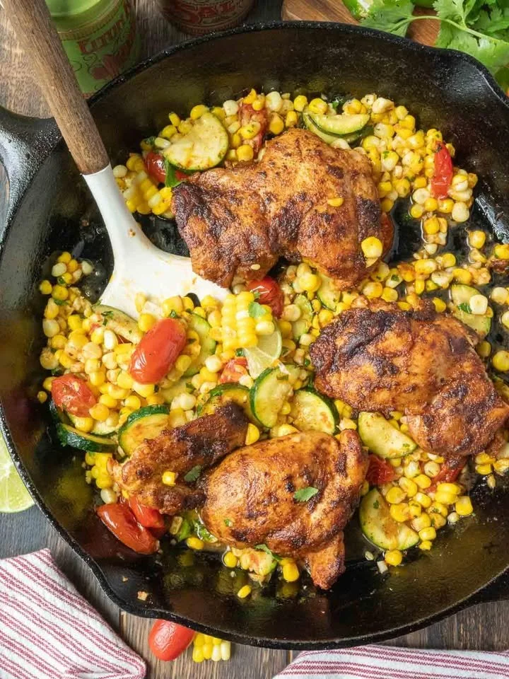 Delicious cilantro lime chicken thighs on a plate with fresh herbs