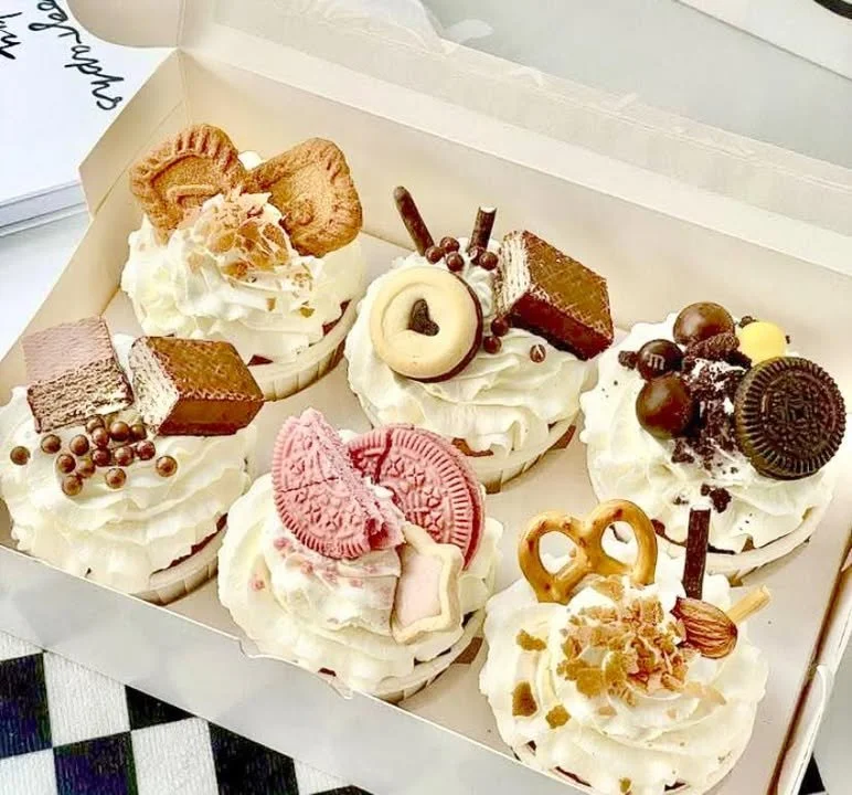 Assorted dreamy cupcakes decorated with frosting and sprinkles