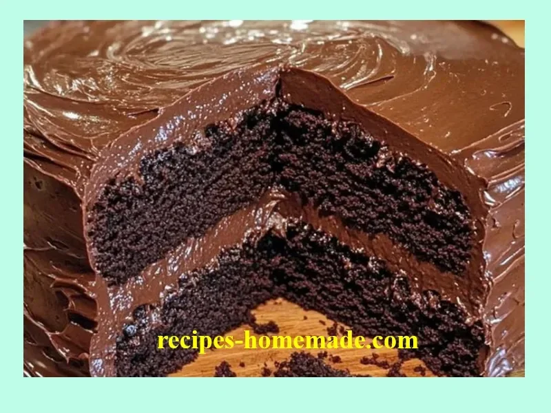 Delicious slice of old-fashioned chocolate cake topped with chocolate icing