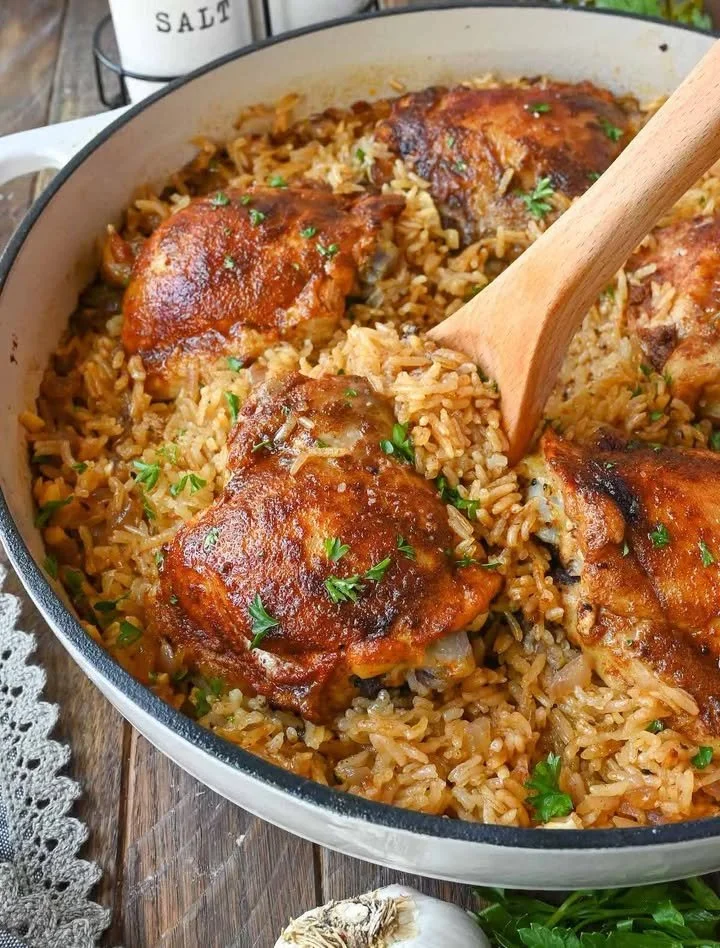 Paprika Chicken and Rice Bake topped with fresh herbs in a baking dish