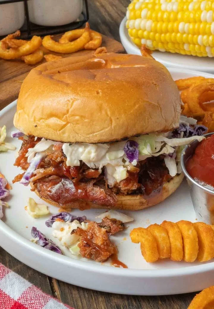 Slow cooker pulled pork sandwiches with barbecue sauce on a plate