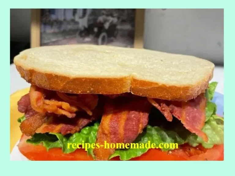 Delicious bacon and tomato sandwiches on a plate with fresh ingredients