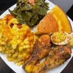 Delicious baked chicken dinner served with vegetables on a plate.