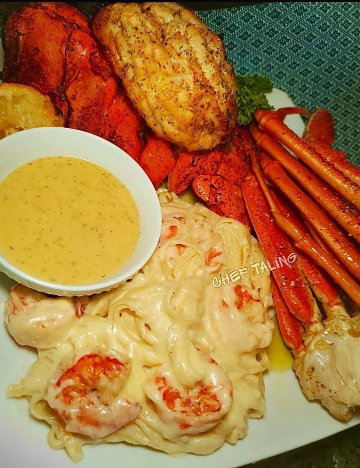 Delicious butter and herb roasted lobster on a plate, garnished and ready to serve.
