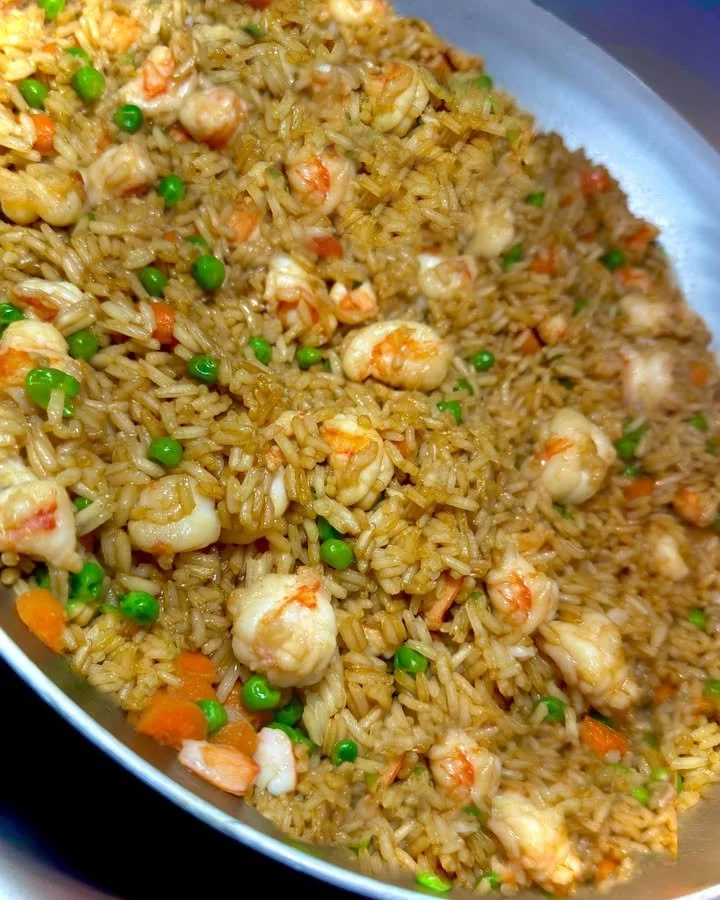 Chopped Shrimp Fried Rice garnished with fresh vegetables and herbs