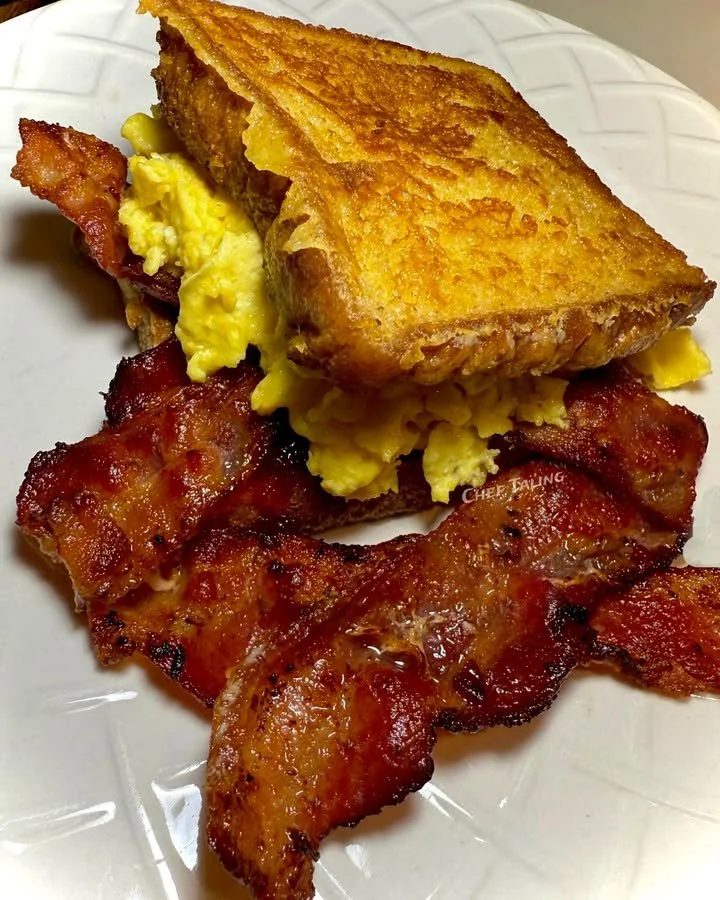 Cinnamon French Toast Breakfast Sandwich with syrup and fruit on a plate
