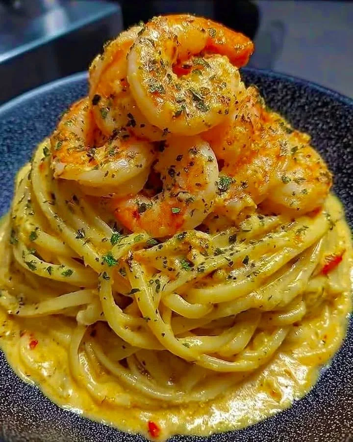 Plate of creamy cheddar sauced linguine with shrimp and herbs