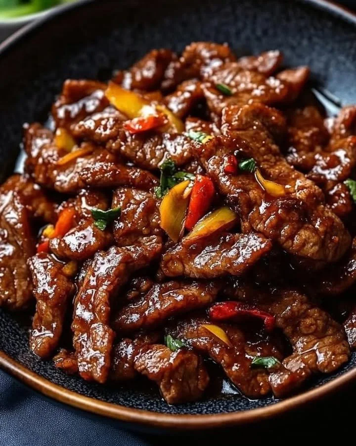 Plate of Crispy Chili Beef garnished with herbs and spices