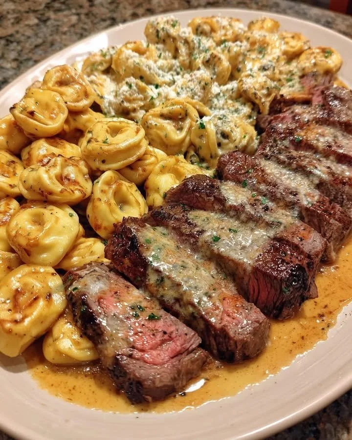 Creamy Philly cheesesteak tortellini bake with provolone cheese served on a plate
