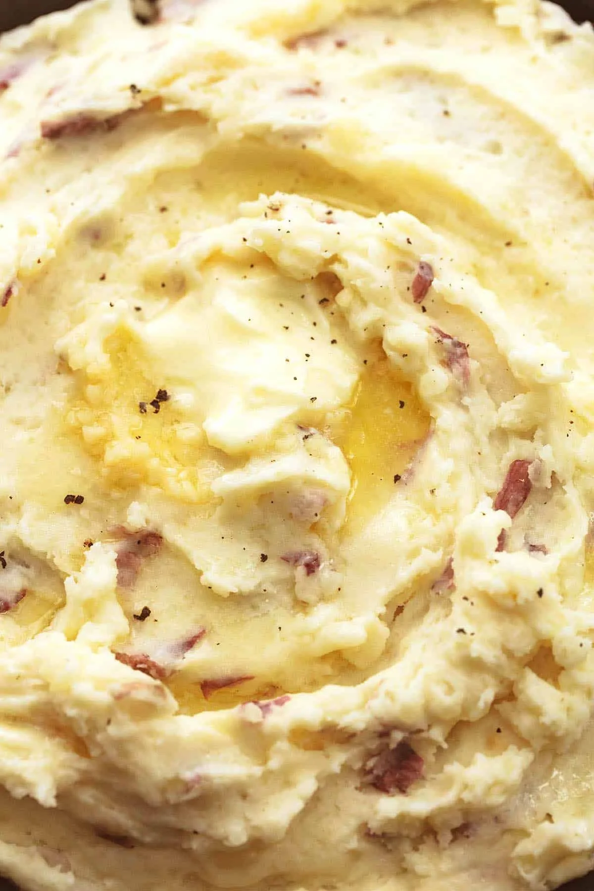 Delicious garlic mashed potatoes on a plate with garnishing