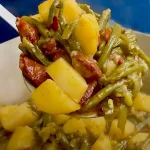 Delicious green beans with potatoes and sausage in a skillet