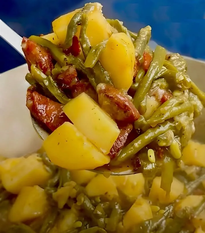 Delicious green beans with potatoes and sausage in a skillet