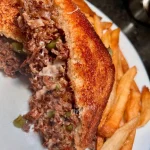 Grilled cheesesteak with sirloin, bell peppers, and melted mozzarella cheese