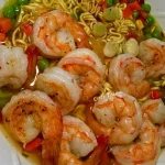 Bowl of homemade shrimp ramen with fresh ingredients and vibrant colors