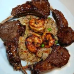Plate of Lamb & Shrimp Fried Rice garnished with vegetables