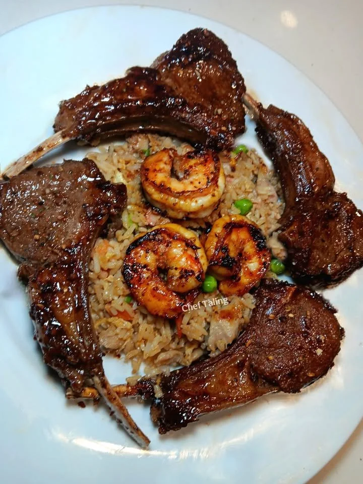 Plate of Lamb & Shrimp Fried Rice garnished with vegetables