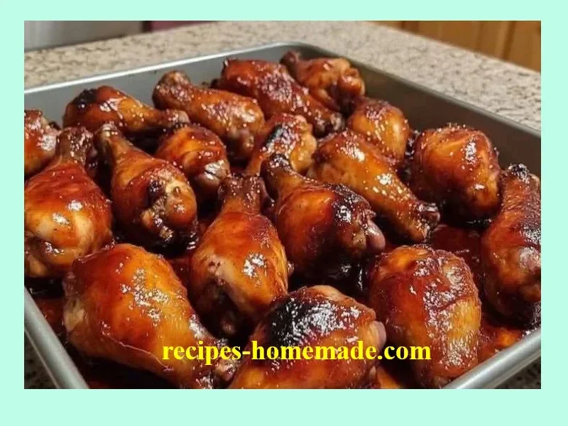 Oven baked BBQ chicken wings garnished with herbs on a serving plate