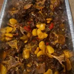 Delicious oxtails with butter beans and red peppers served in a bowl.