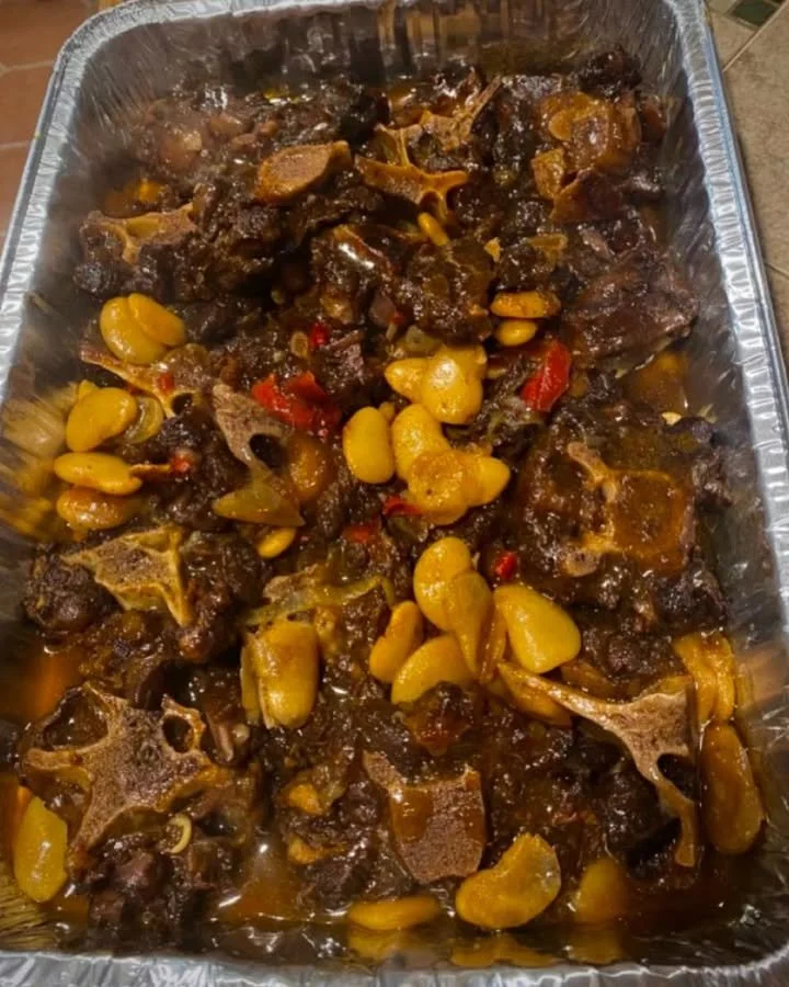 Delicious oxtails with butter beans and red peppers served in a bowl.