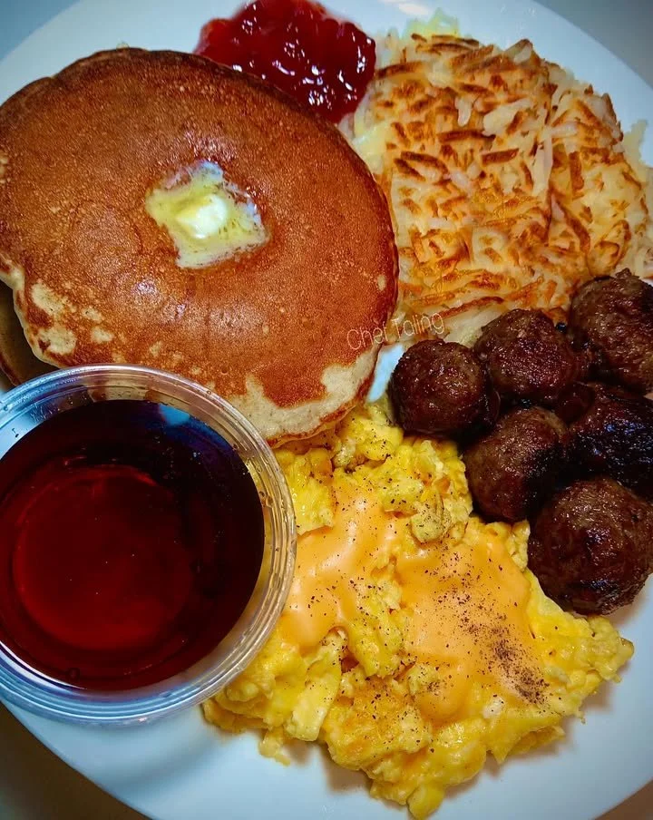 Pancakes served with Italian sausage balls for a hearty breakfast.
