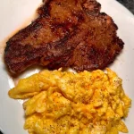 Delicious peppery cheese eggs served with T-bone steak.