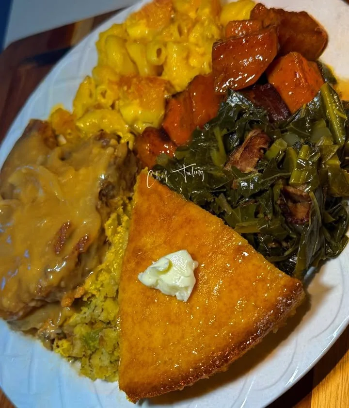 Plate of smothered pork chops in savory sauce garnished with herbs