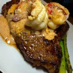 Steak and double lobster tails in spiced Caesar cream sauce, a gourmet dish