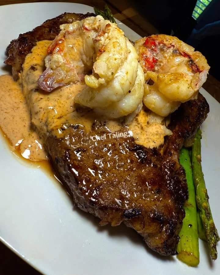 Steak and double lobster tails in spiced Caesar cream sauce, a gourmet dish